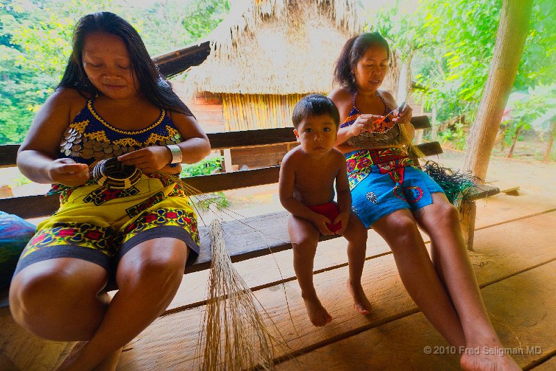 20101203_120035 D3S-Edit.jpg - Two Embera women making baskets.   Until recently the women were bare-breasted most of the time